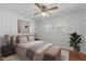 Cozy bedroom with a ceiling fan, window and neutral furnishings at 413 Hocutt Rd, Durham, NC 27703