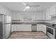 Clean kitchen featuring stainless steel appliances, ample counter space, and white cabinets at 413 Hocutt Rd, Durham, NC 27703