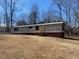 Exterior view of single-story home featuring horizontal siding and red window shutters at 415 Island Creek Estates Rd, Henderson, NC 27537