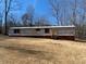 Exterior view of single-story home featuring horizontal siding and red window shutters at 415 Island Creek Estates Rd, Henderson, NC 27537