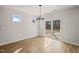 Bright dining room featuring a modern chandelier, sliding glass door, and hardwood floors at 474 W Ravano Dr, Clayton, NC 27527