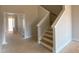 Bright entryway features staircase and view through to the front door at 4875 Grosbeak Ct, Mebane, NC 27302