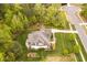 Aerial view of a home with a well-maintained lawn and landscaping, situated amongst mature trees at 5040 Shakori Trl, Chapel Hill, NC 27707