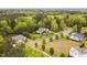 Aerial view of a neighborhood with large homes, mature trees, and green lawns at 5040 Shakori Trl, Chapel Hill, NC 27707
