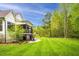 Beautiful backyard featuring a covered porch, patio, and large grassy area, perfect for outdoor entertaining at 5040 Shakori Trl, Chapel Hill, NC 27707