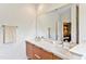 Modern bathroom featuring a double vanity, large mirror, and neutral colors at 5040 Shakori Trl, Chapel Hill, NC 27707