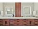 Bathroom featuring double sinks, quartz countertops, and abundant cabinet storage at 5040 Shakori Trl, Chapel Hill, NC 27707