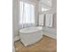 Spa bathroom featuring a freestanding tub, neutral tiling, and natural light at 5040 Shakori Trl, Chapel Hill, NC 27707