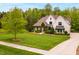 Beautiful two-story home with painted brick, landscaped lawn, and charming curb appeal at 5040 Shakori Trl, Chapel Hill, NC 27707