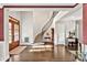 Bright foyer showcasing the curved staircase, hardwood floors, and detailed trim throughout at 5040 Shakori Trl, Chapel Hill, NC 27707