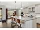 Spacious kitchen with a large island, bar stools, stainless steel appliances, and stylish decor at 5040 Shakori Trl, Chapel Hill, NC 27707
