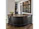 A kitchen with elegant black bar area featuring wine storage and decorative glass display cabinets at 5040 Shakori Trl, Chapel Hill, NC 27707