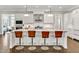 Modern kitchen boasting a large island with seating, stainless steel appliances, and ample storage at 5040 Shakori Trl, Chapel Hill, NC 27707
