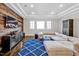 Spacious living room featuring modern rustic accent wall, recessed lighting, and large sectional sofa at 5040 Shakori Trl, Chapel Hill, NC 27707