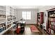 Inviting home office with built-in bookshelves, dark wood floors, large desk, and great natural light at 5040 Shakori Trl, Chapel Hill, NC 27707