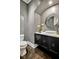 Stylish powder room featuring textured wallpaper, vessel sink, and a modern aesthetic at 5040 Shakori Trl, Chapel Hill, NC 27707