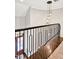 The staircase offers a stylish modern design with decorative black metal railing and hanging light fixture at 5040 Shakori Trl, Chapel Hill, NC 27707