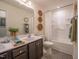 Bathroom features double sink, framed mirror, decorative wall hangings, and shower-tub combo at 505 Marthas View Way, Wake Forest, NC 27587