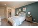 Bedroom with neutral carpet, teal accent wall, and closet space near the entry door at 505 Marthas View Way, Wake Forest, NC 27587
