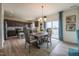 Dining area connected to an open kitchen, featuring hardwood floors and modern appliances at 505 Marthas View Way, Wake Forest, NC 27587