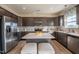 Bright kitchen featuring stainless steel appliances, a kitchen island with seating, and gray cabinets at 505 Marthas View Way, Wake Forest, NC 27587