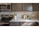 Kitchen featuring stainless steel appliances, gray cabinets, and white countertops and backsplash at 505 Marthas View Way, Wake Forest, NC 27587