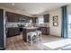 Well-lit kitchen features stainless steel appliances, a kitchen island with bar seating, and gray cabinets at 505 Marthas View Way, Wake Forest, NC 27587