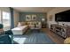 Comfortable living room with an L-shaped sofa, blue accent wall, and wood-style flooring at 505 Marthas View Way, Wake Forest, NC 27587