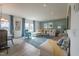Spacious living room with a large sofa, accent chair, and seamless flow into the dining area at 505 Marthas View Way, Wake Forest, NC 27587