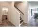 Open staircase leading to the upstairs, featuring hardwood floors and white railings for a modern look at 505 Marthas View Way, Wake Forest, NC 27587