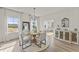 Elegant dining area with a round table set for four and ample natural light from large windows at 509 Marthas View Way, Wake Forest, NC 27587