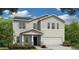 Two-story home showcasing detailed siding and a two-car garage, complemented by a well-manicured lawn and vibrant landscaping at 509 Marthas View Way, Wake Forest, NC 27587