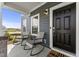 Inviting front porch featuring modern rocking chairs and a sleek, black front door at 509 Marthas View Way, Wake Forest, NC 27587