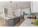 Modern kitchen with stainless steel appliances, a kitchen island, and open access to stairs at 509 Marthas View Way, Wake Forest, NC 27587