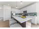 Bright kitchen with an island, pendant lighting, stainless appliances, and white cabinetry at 509 Marthas View Way, Wake Forest, NC 27587