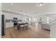 Open kitchen with stainless steel appliances, island seating, and a view of the living area at 509 Marthas View Way, Wake Forest, NC 27587