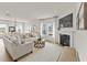 Bright living room with a fireplace, large sofa, and an ornate coffee table at 509 Marthas View Way, Wake Forest, NC 27587