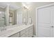 Bathroom with a large mirror, double sinks, and white cabinets at 510 Mariah Towns Way, Garner, NC 27529