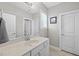 This bathroom features a sleek vanity with a white marble countertop, ample lighting, and a decorative picture at 510 Mariah Towns Way, Garner, NC 27529