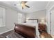 Cozy bedroom with hardwood floors, ceiling fan, and a large window at 510 Mariah Towns Way, Garner, NC 27529