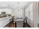 Bright dining area with stylish chandelier lighting, seating for four and adjacent kitchen at 510 Mariah Towns Way, Garner, NC 27529