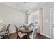 Cozy dining area features a round table, decorative chandelier, and natural light from the adjacent window at 510 Mariah Towns Way, Garner, NC 27529