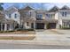 Attractive townhome showcasing a well-manicured lawn, a two-car garage, and a welcoming entrance at 510 Mariah Towns Way, Garner, NC 27529