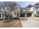 Charming townhome featuring a beige exterior, attached garage, and well-manicured landscaping at 510 Mariah Towns Way, Garner, NC 27529