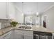 Modern kitchen with granite countertops, stainless steel appliances, a double sink and hanging pendant lights at 510 Mariah Towns Way, Garner, NC 27529