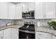 Close up of kitchen featuring granite countertops, subway tile backsplash and stainless steel oven at 510 Mariah Towns Way, Garner, NC 27529