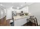 Open kitchen with stainless steel appliances, granite countertops and barstool seating at the island at 510 Mariah Towns Way, Garner, NC 27529