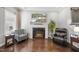 Comfortable living area featuring a fireplace with a mounted TV, hardwood floors and cozy seating at 510 Mariah Towns Way, Garner, NC 27529