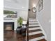 Inviting living room with a cozy fireplace and elegant staircase at 510 Mariah Towns Way, Garner, NC 27529
