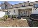 Outdoor patio with ceiling fan, string lights, grill, and chairs provides an excellent entertaining space at 510 Mariah Towns Way, Garner, NC 27529